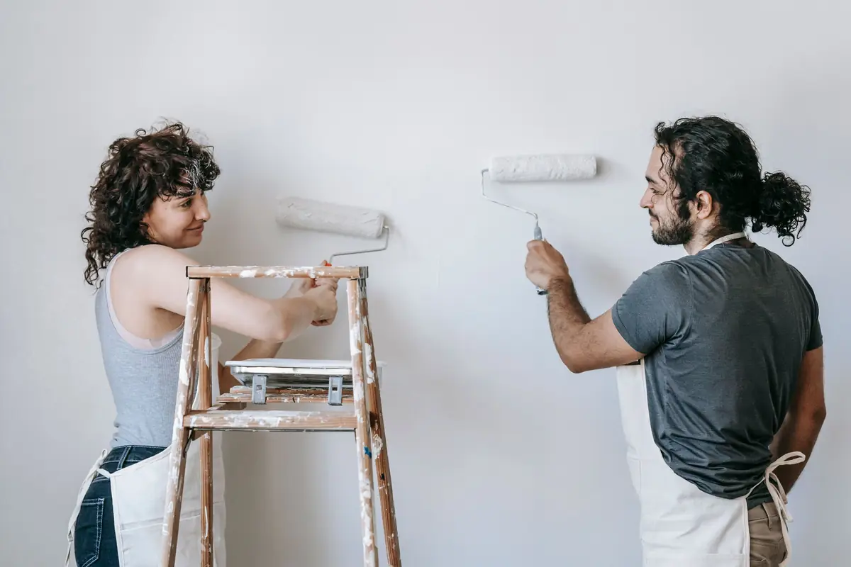 People painting a wall together — painting help in Abilene