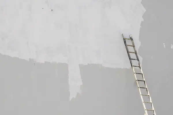 Exterior painting in Abilene: ladder against a freshly primed wall