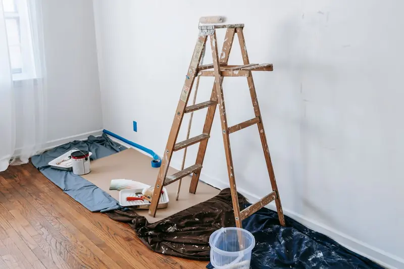 Rental turnover painting in Abilene: empty unit with fresh white walls and a stepladder