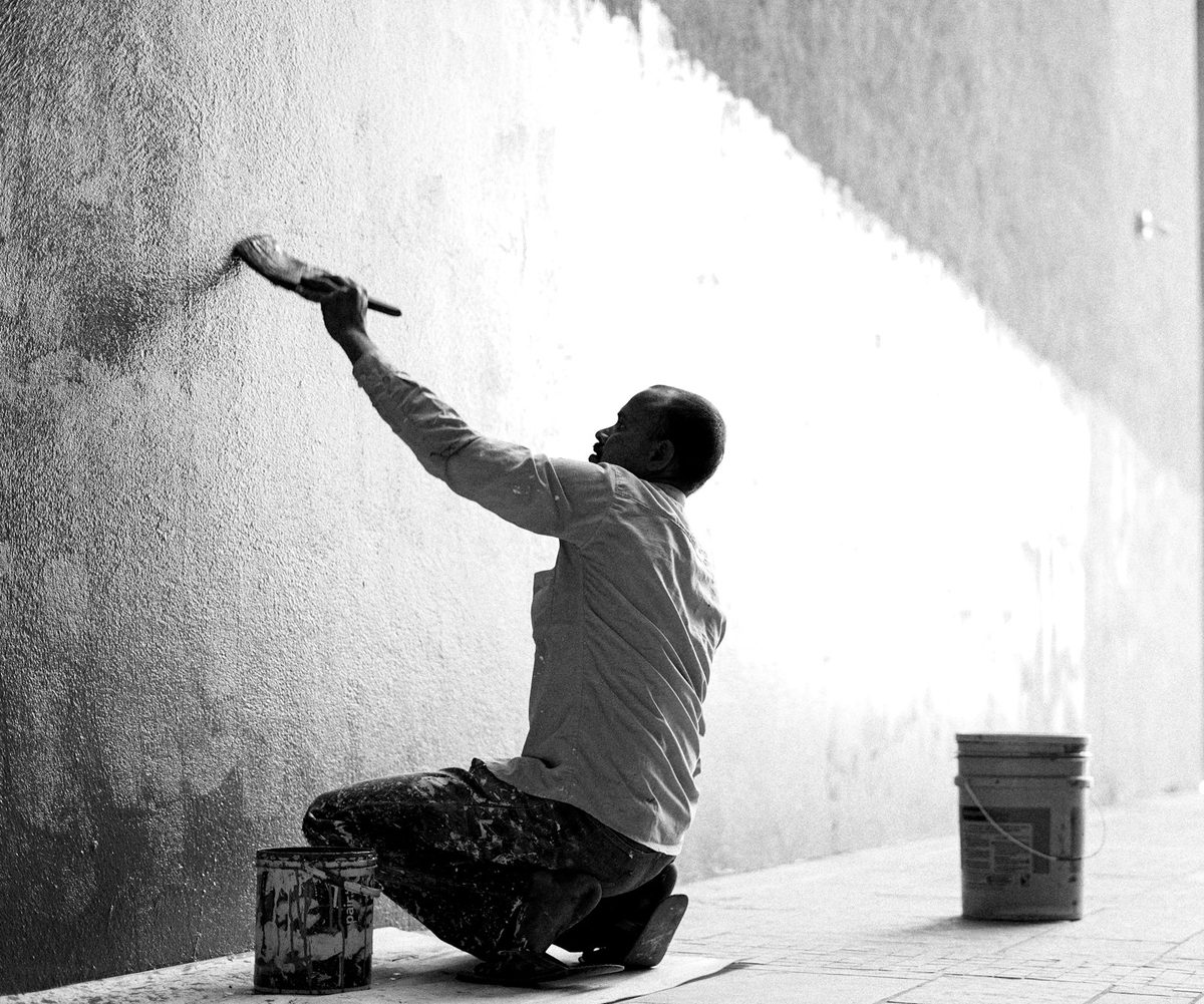 Painter working on a building exterior